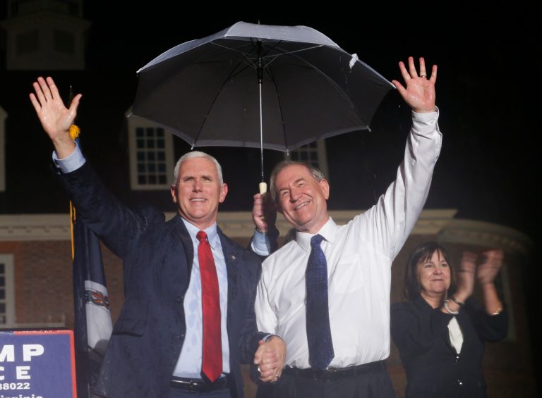 Vice President Mike Pence, left, waves to the crowd along with former Virginia Gov. Jim Gilmore, right, during a 2016 Trump-Pence rally in front of the Colonial Capitol in Williamsburg, Va., Tuesday, Sept. 20, 2016. 