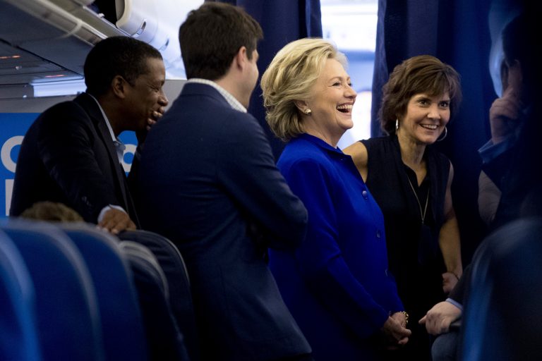 2016 Democratic presidential candidate Hillary Clinton, third from left, speaks with Traveling Political Adviser Darren Peters, left, Traveling Press Secretary Nick Merrill, and former State Department official Capricia Marshall.