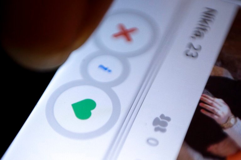 A man uses the dating app Tinder.