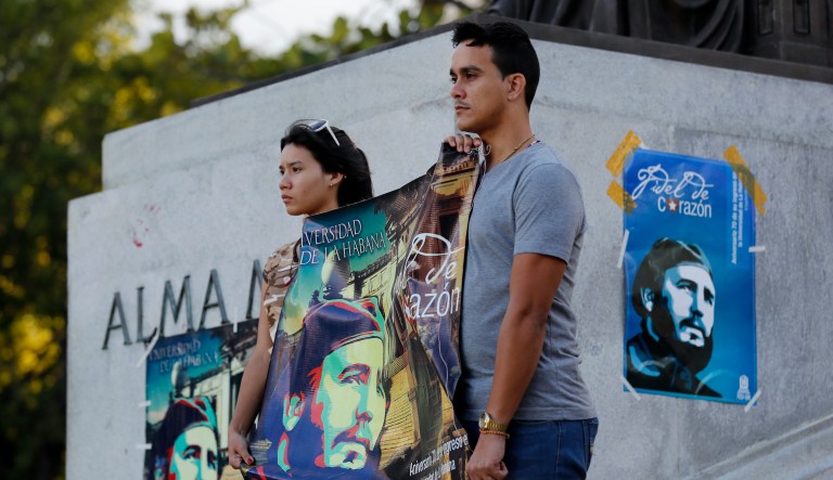 Students stand at attention holding images of Fidel Castro at the university where Castro studied law as a young man, during a vigil in Havana, Cuba, Sunday, Nov. 27, 2016. Castro, who led a rebel army to improbable victory in Cuba, embraced Soviet-style communism and defied the power of U.S. presidents during his half century rule, died at age 90.
