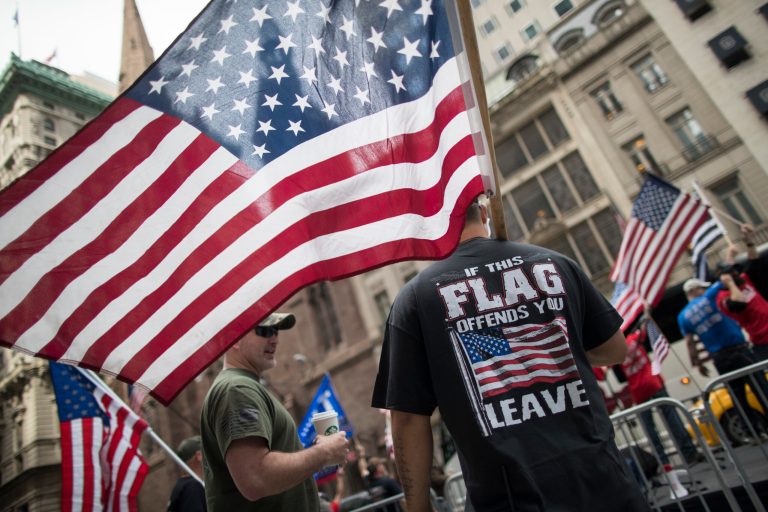 Demonstrators hold American flags during a rally near Trump Tower, Saturday, June 3, 2017, in New York. The rally in support of President Trump and his policy to build a wall on the Mexican border was organized by America First Foundation.
