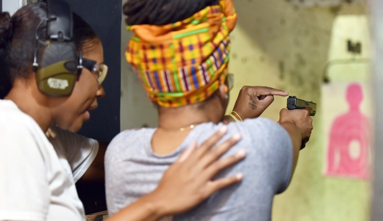 In this May 27, 2017, photo,Marchelle Tigner, a firearms instructor, teaches a student how to shoot a gun during a class in Lawrenceville, Ga. Tigner's goal is to train 1 million women how to shoot a gun in her lifetime. She is among the nation's black women gun owners who say they are picking up firearms for self-protection.