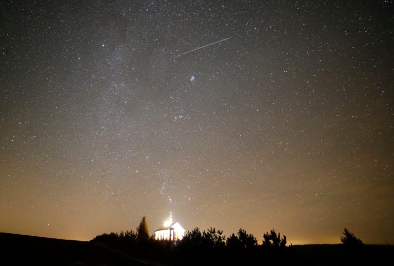 A meteor streaks across the sky during the annual Geminid meteor shower over an Orthodox church on the local cemetery near the village of Zagorie, some 110 km (69 miles) west of Minsk, Belarus, on Dec. 13, 2017.