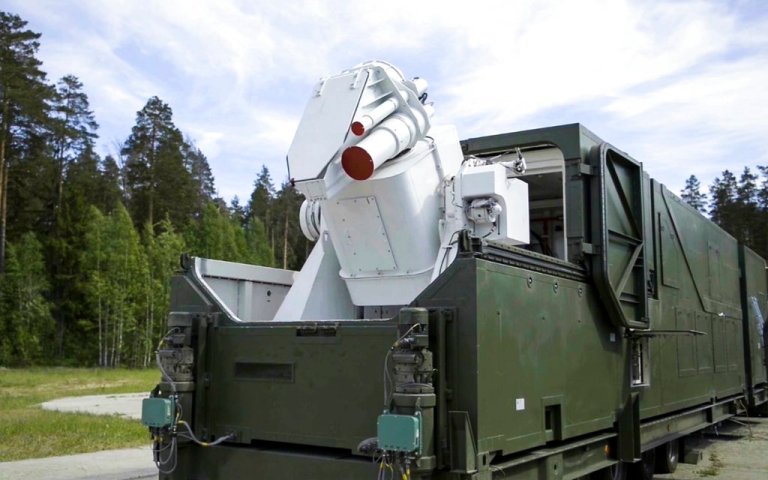 A Russian military truck with a laser weapon mounted on it is shown at an undisclosed location in Russia.