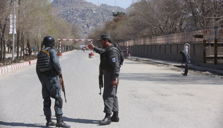 Police patrol the streets after a suicide attack in front of the Kabul university in Kabul, Wednesday. Afghan officials are reporting a large explosion on the road to a Shiite shrine in the capital, where people had gathered to mark the Persian new year.