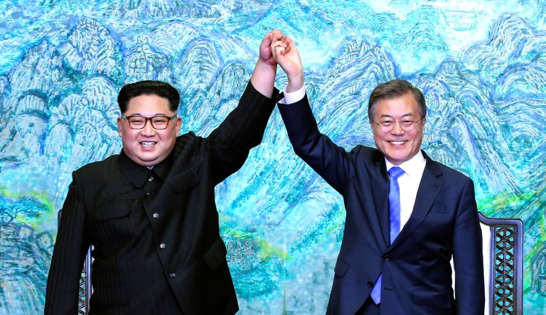 North Korean leader Kim Jong Un and South Korean President Moon Jae-in raise their hands after signing a joint statement at the border village of Panmunjom in the Demilitarized Zone, South Korea. 