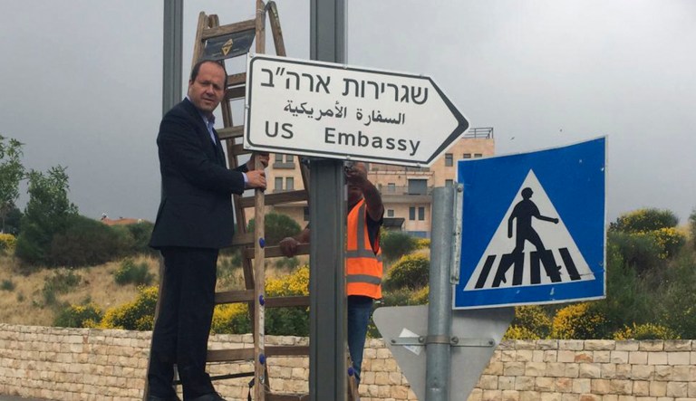  Jerusalem Mayor Nir Barkat poses with a new road sign to the new U.S. Embassy in Jerusalem, Monday. Jerusalem's city hall says it has put up road signs pointing to the new U.S. Embassy, which is set to move to the contested city next week.