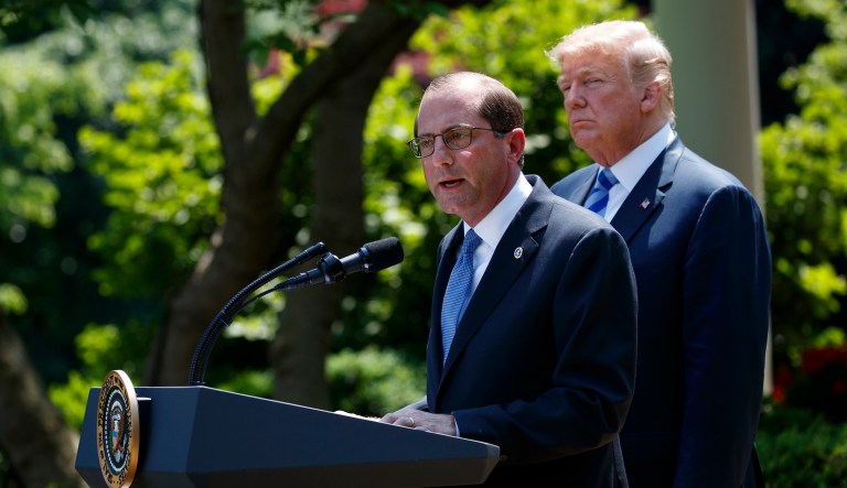 President Trump listens as Secretary of Health and Human Services Alex Azar speaks during an event about prescription drug prices. 