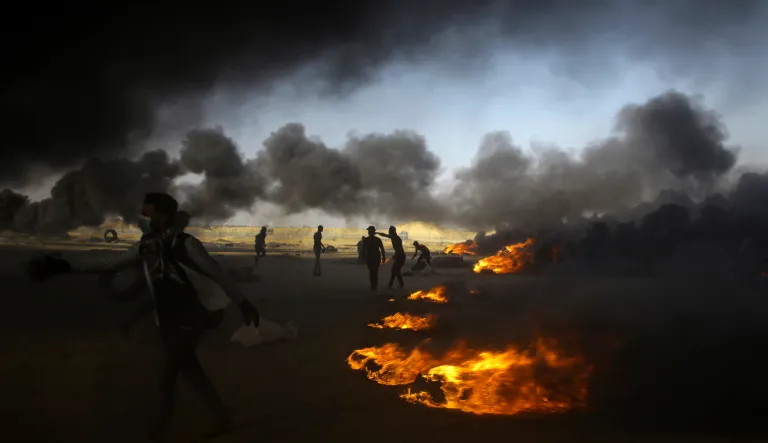 Palestinian protesters burn tires during a protest at the Gaza Strip's border with Israel. Israel faced a growing backlash Tuesday and new charges of using excessive force, a day after Israeli troops firing from across a border fence killed dozens of Palestinians and wounded more than 2,700 at a mass protest in Gaza. 