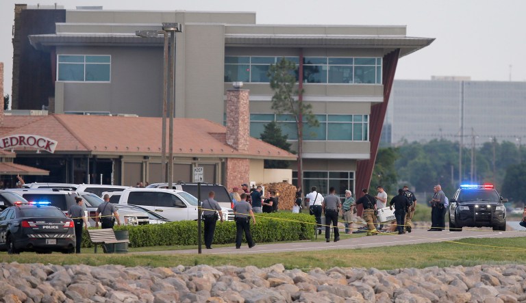A man armed with a pistol walked into a restaurant at the dinner hour and opened fire, wounding two customers, before being shot dead by a handgun-carrying civilian in the parking lot, police said.