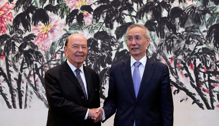 Commerce Secretary Wilbur Ross shakes hands with Chinese Vice Premier Liu He as they pose for photographers after their meeting in Beijing, Sunday. 