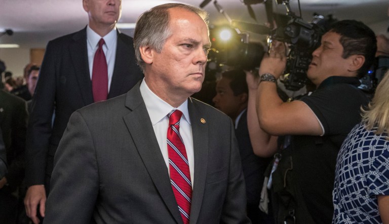 James Wolfe, center, former director of security with the Senate Intelligence Committee, has been accused by federal prosecutors for lying to the FBI about contact he had with reporters who covered the committee. 