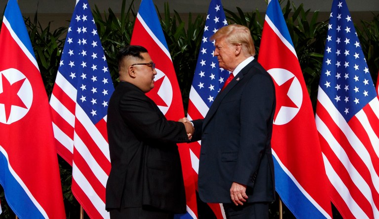 North Korean leader Kim Jong Un and President Trump shake hands prior to their meeting on Sentosa Island in Singapore. 