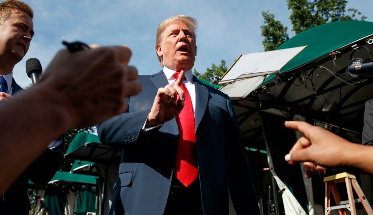 President Trump speaks to reporters on the North Lawn of the White House. 