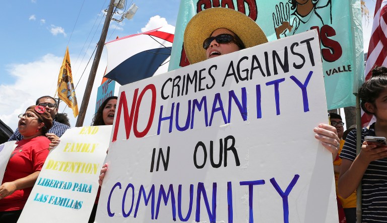 Stefanie Herweck stands with other protesters in front of the U.S. Customs and Border Protection's Rio Grande Valley Sector's Centralized Processing Center on Sunday, June 17, 2018, in McAllen, Texas. The U.S. Border Patrol on Sunday allowed reporters to briefly visit the facility where it holds families arrested at the southern U.S. border, responding to new criticism and protests over the Trump administration's "zero tolerance" policy and resulting separation of families.