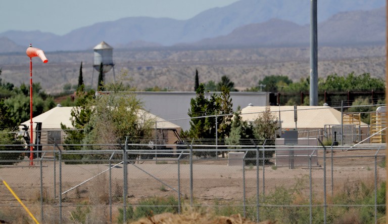 Mexico backdrops tent shelters used to hold separated migrant family members along the International border. 