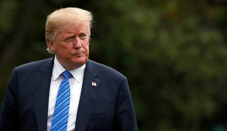 President Trump walks on the South Lawn after stepping off Marine One at the White House. 