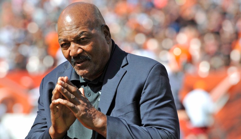 Former running back Jim Brown stands on the field during a halftime ceremony of an NFL football game. 