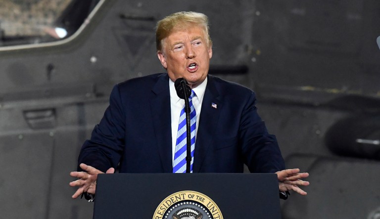 President Trump speaks before signing a $716 billion defense policy bill in Fort Drum, N.Y. 