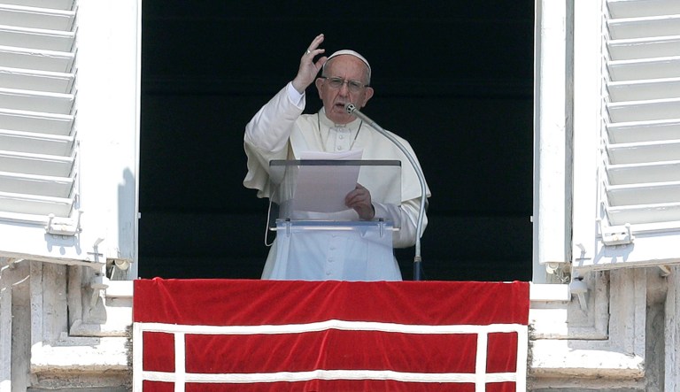 Pope Francis delivers a blessing during the Angelus noon prayer in St. Peter's Square, at the Vatican. 