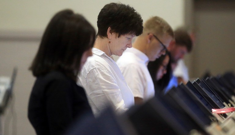 Voters casts their ballots during the primary election in Laramie, Wyo. 