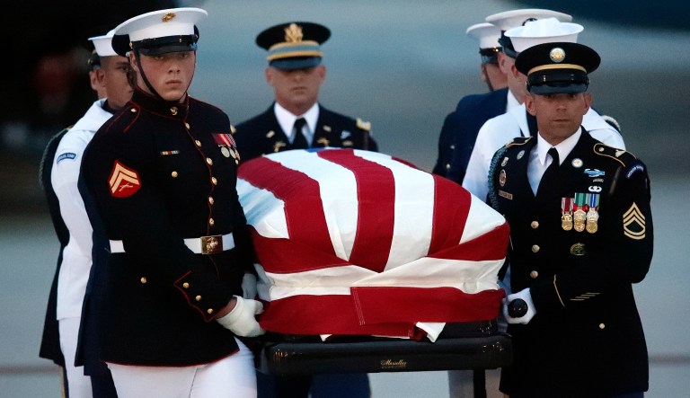 The flag-draped casket of Sen. John McCain, R-Ariz., is carried by an Armed Forces body bearer team to a hearse at Andrews Air Force Base, Md. 