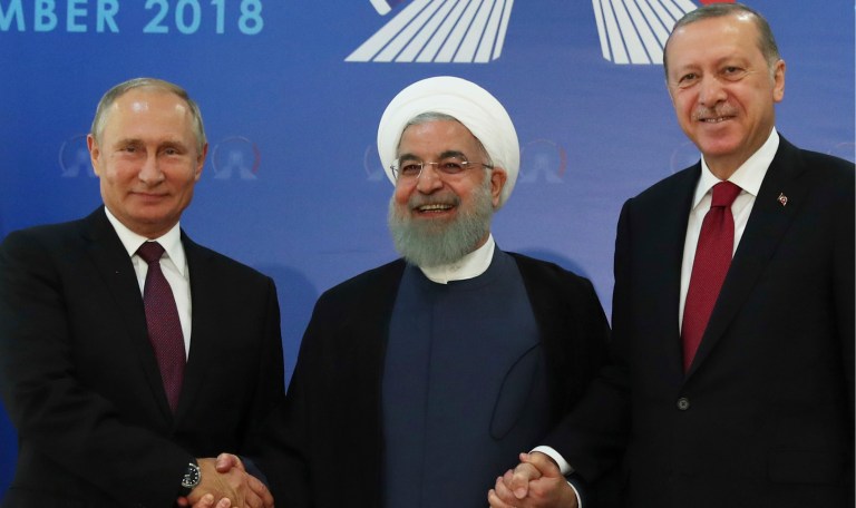 Iran's President Hassan Rouhani, flanked by Russia's President Vladimir Putin, and Turkey's President Recep Tayyip Erdogan, in Tehran, Iran, ahead of their summit to discuss Syria. The three leaders began a meeting to discuss the war in Syria.