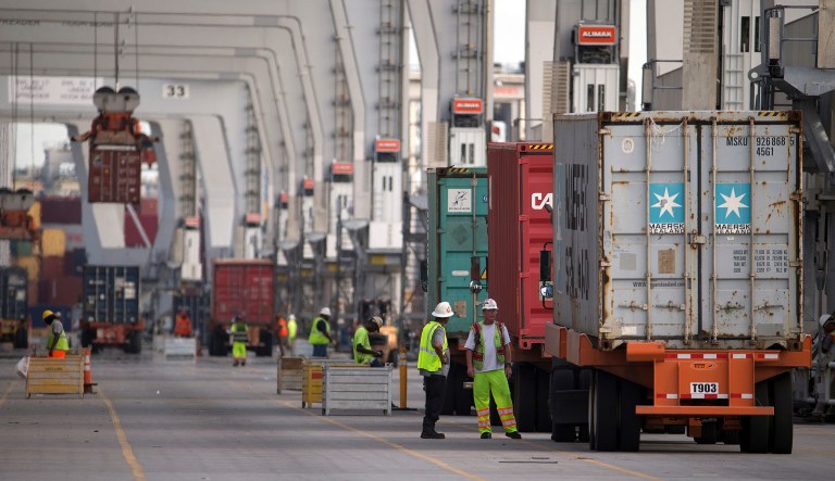 Dockworkers discuss the placement of a 40-foot shipping container onto a ship at the Port of Savannah in Savannah, Ga. China has promised retaliation if Washington goes ahead with more tariff hikes, raising the risk Beijing might target operations of American companies if it runs out of imports for penalties. 