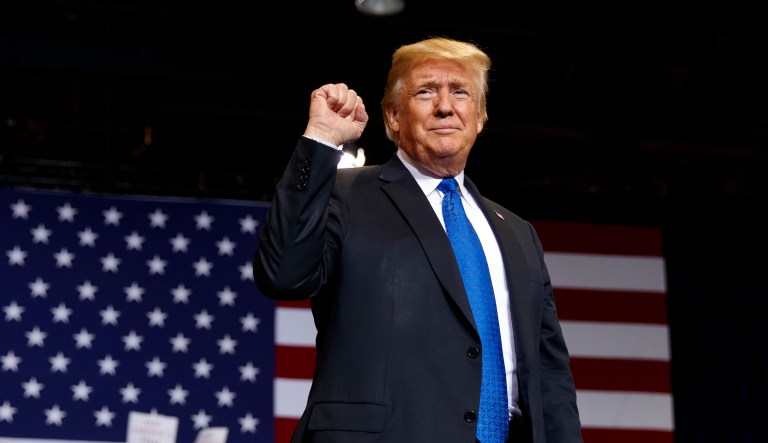 President Trump pumps his fist as he arrives to a campaign rally in Las Vegas. 