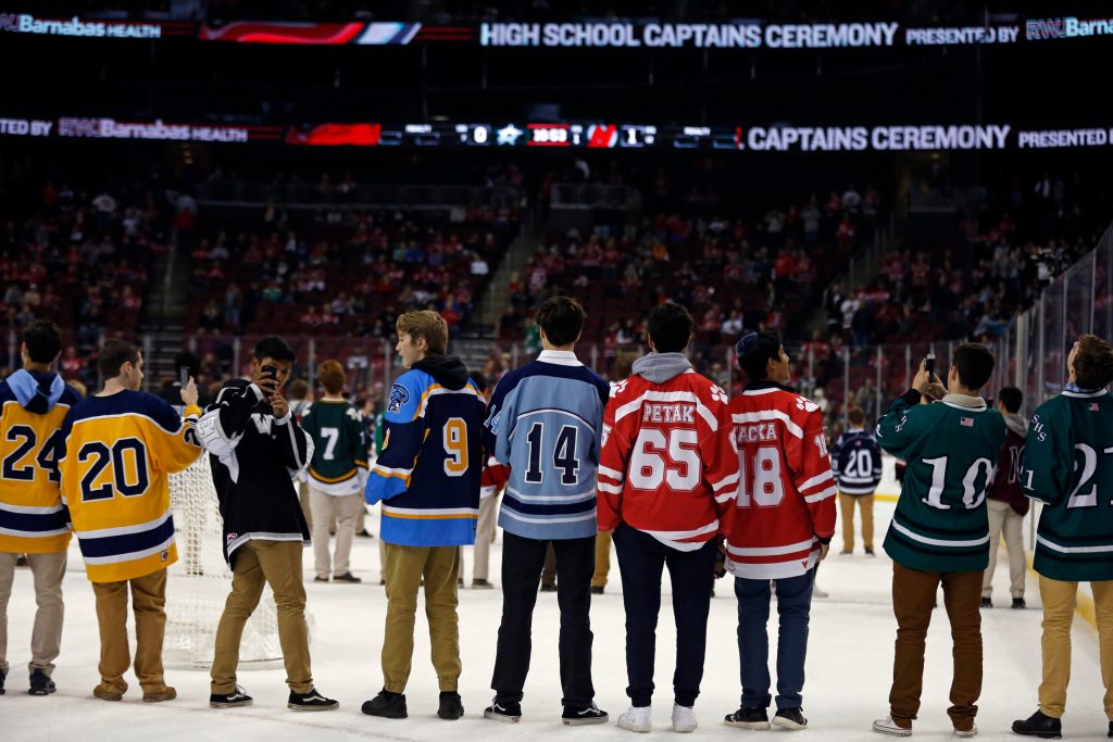 High school slammed as racist after elementary-age hockey fans flash 'OK' symbol