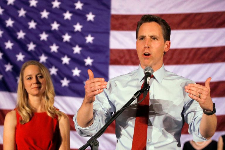 Josh Hawley makes his victory speech while his wife Erin watches during an election watch party Tuesday, Nov. 6, 2018, in Springfield, Mo. (AP Photo/Charlie Riedel)
