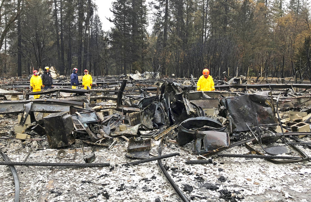 Rain tamps down California fire but turns grim search soggy
