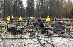 Rain tamps down California fire but turns grim search soggy