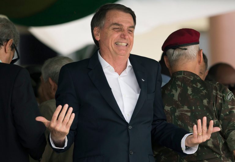 Brazil's then-President-elect Jair Bolsonaro smiles during a ceremony marking the 73rd anniversary of the Brazilian Paratrooper Infantry Brigade in Rio de Janeiro, Brazil, Saturday, Nov. 24, 2018.