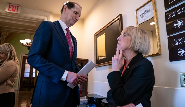 Sen. Ron Wyden, D-Ore., left, and Sen. Patty Murray, D-Ore., wait for Sen. Joe Manchin, D-W.Va., before a news conference to press Congress to intervene on behalf of the Affordable Care Act, after a federal judge in Texas ruled it unconstitutional, on Capitol Hill in Washington, Wednesday, Dec. 19, 2018.