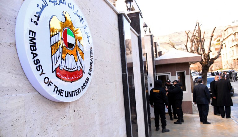 In this photo released by the Syrian official news agency SANA, officials and journalists gather outside the embassy of the United Arab Emirates, in Damascus, Syria, Thursday, Dec. 27, 2018. Syria said the UAE will reopen its embassy in Damascus on Thursday, for the first time in seven years, a reflection of improved relations between President Bashar Assad and some of his Arab foes as the war winds down.