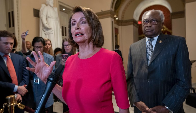 Speaker of the House Nancy Pelosi, D-Calif., center, joined at right by Majority Whip James Clyburn, D-S.C., pushes back on President Trump's demand to fund a wall on the US-Mexico border with the partial government shutdown in its second week, at the Capitol in Washington, Thursday, Jan. 3, 2019. 