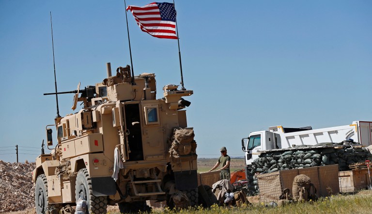 In this April 4, 2018 file photo, a U.S. soldier stands in a newly installed position near the front line between the U.S-backed Syrian Manbij Military Council and the Turkish-backed fighters, in Manbij, north Syria.