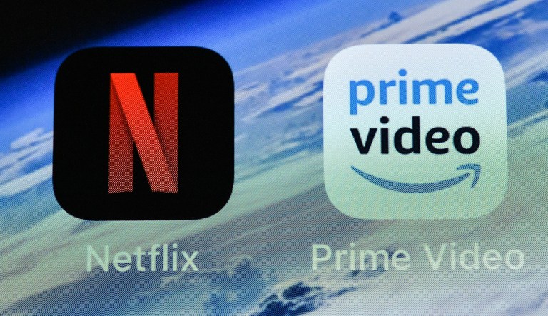In this Thursday, Nov. 15, 2018 file photo, the icons of streaming services Netflix and AmazonPrime Video are pictured on an iPhone in Gelsenkirchen, Germany. Streaming your favorite movies and TV shows is about to get way more expensive.