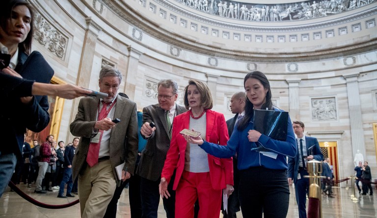 House Speaker Nancy Pelosi of California, center, speaks to reporters as she leaves an event with furloughed federal workers amid the partial government shutdown, Wednesday, Jan. 16, 2019, on Capitol Hill in Washington. 