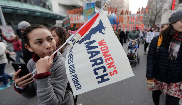 A participant in the Seattle Women's March carries a flag, Saturday, Jan. 19, 2019 in downtown Seattle. Cities big and small across the Pacific Northwest held versions or multiple versions of the Women's March over the weekend, mirroring a national march in Washington, D.C. 