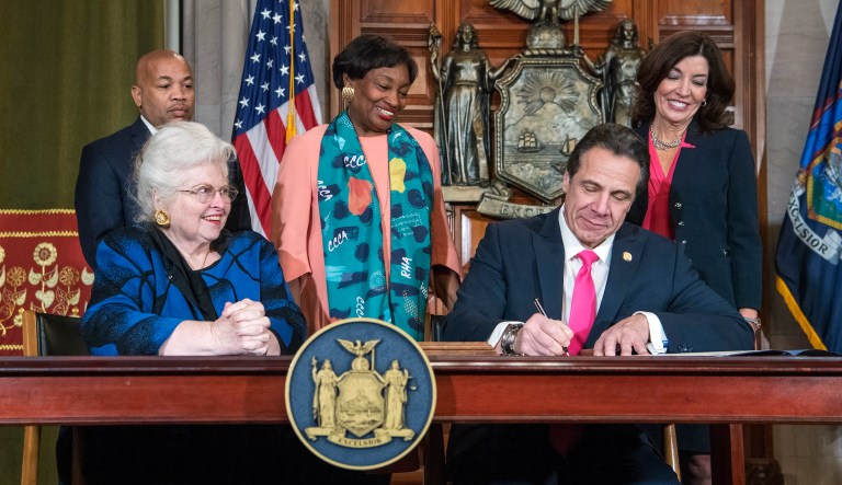 In this photo provided by the Office of Gov. Andrew M. Cuomo, Cuomo, right, signs Reproductive Health Act Legislation during a ceremony, Tuesday, Jan. 22, 2019, in the Red Room at the State Capitol in Albany, N.Y. With the new law, New York state enacts one of the nation's strongest protections for abortion rights, a move that state leaders say was needed to safeguard those rights should the U.S. Supreme Court overturn Roe v. Wade. Also pictured are attorney Sarah Weddington, front left, who successfully argued Roe v Wade before the Supreme Court; New York State assembly Speaker Carl Heastie, back left; New York State Senate Leader Andrea Stewart-Cousins, D-Yonkers, standing center; and Democratic Lt. Gov Kathy Hochul, back right.