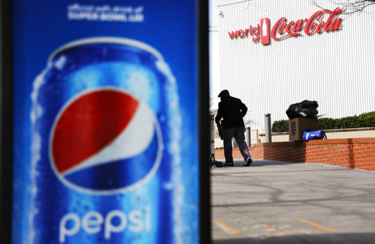 A Pepsi advertisement stands outside the World of Coca-Cola museum as a vendor stocks his kiosk in Atlanta, Wednesday, Jan. 30, 2019. The Patriots and the Rams aren't the only ones battling for Super Bowl supremacy this week. Pepsi and Coke also seem to be squaring off. Pepsi, an official NFL sponsor of Super Bowl 53, has invaded Coke's home turf, its headquarters are in Atlanta. 