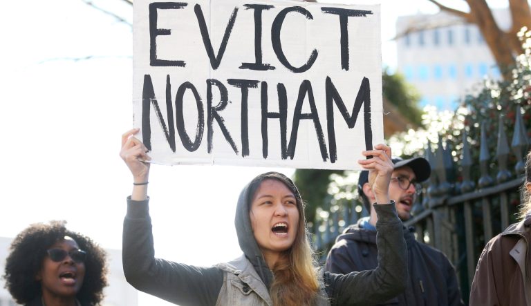 Geraldine Mabagos, of Richmond, holds a sign during a protest in Richmond calling for Gov. Ralph Northam to resign on Monday Feb. 4, 2019.