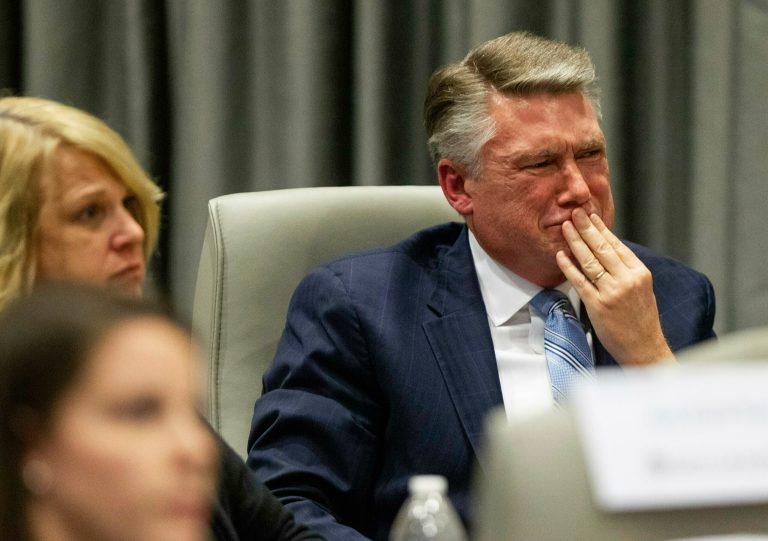 Mark Harris, Republican candidate in North Carolina's 9th Congressional race, fights back tears at the conclusion of his son John Harris's testimony during the third day of a public evidentiary hearing.