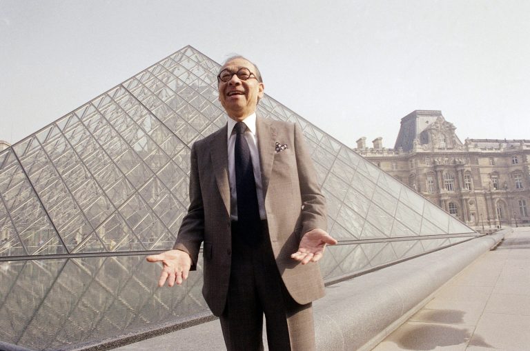 Architect I.M. Pei laughs while posing for a portrait in front of the Louvre glass pyramid, which he designed, in the museum's Napoleon Courtyard.