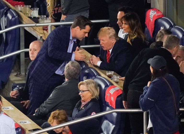 Rep. Matt Gaetz, R-Fla., stands up to talk to President Donald Trump, right seated, as they sit with other Republican lawmakers during Game 5 of baseball World Series between the Houston Astros and Washington Nationals, Sunday, Oct. 27, 2019, at Nationals Park in Washington. Gaetz, influential in the Trump circle, has just authored a new book, "Firebrand."