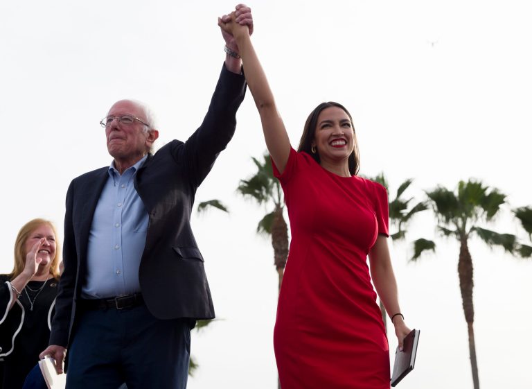 Democratic presidential candidate Sen. Bernie Sanders, I-Vt., and Rep. Alexandria Ocasio-Cortez, D-N.Y., greet the crowd during a rally in Venice, Calif., Saturday, Dec. 21, 2019. A new survey shows concerns about socialism.