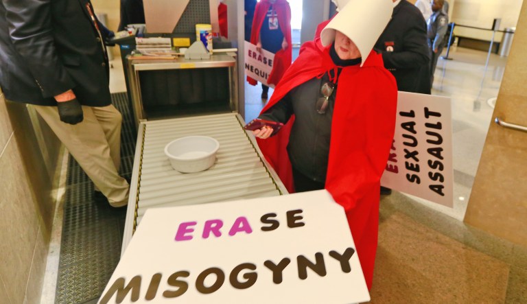 Equal Rights Amendment supporters make their way through security as they arrive for for the 2020 session outside Virginia state Capitol in Richmond, Va., Wednesday, Jan. 8, 2020.