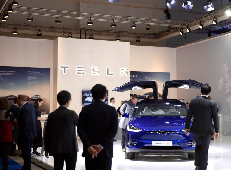 People view the new Tesla Model X during the Brussels Auto Show at the Expo in Brussels, Thursday, Jan. 9, 2020. 